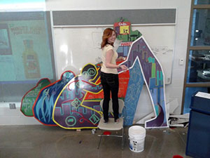 Ashley Bostwick painting mural
